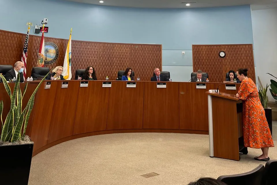 A speaker addressing city commissioners at a Sunny Isles Beach commission meeting
